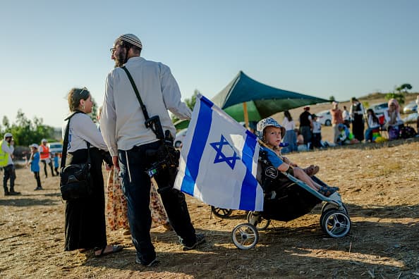 An armed Israeli settler near the Gaza border, where far-right groups have been pushing to re-establish illegal settlements in the Palestinian enclave [Getty]