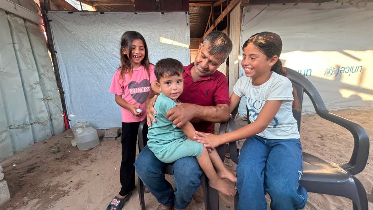 Hatem Jadallah, 44, with his children at the family's tent in al-Mawasi, after a dialysis session at Nasser Medical Complex. Mohammed is three and a half, Mariam ten and Leen eight. Jadallah began dialysis in August 2024 and says the war brought on his kidney failure.