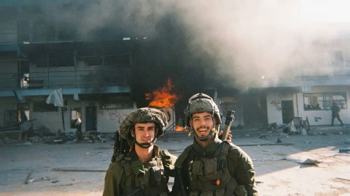 Jonathan Burman and another soldier stand in front of the Madrasa al-Farabi in Gaza. (Obtained by Declassified UK)
