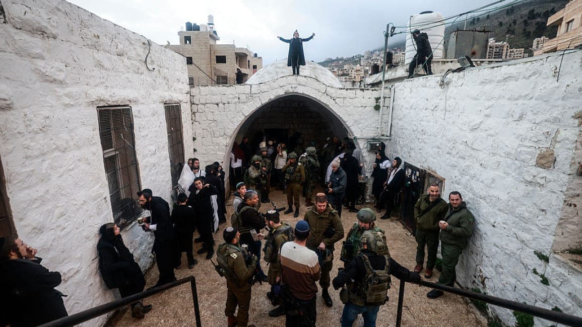 Israeli soldiers and worshippers gather at Joseph's Tomb in Nablus during a visit to the site.