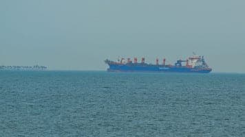 A commercial ship is viewed anchored off the coast of the United Arab Emirates, in the Strait of Hormuz, Dubai on March 2, 2026